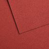 Close-up of red textured panels overlapping with a diagonal seam between them.