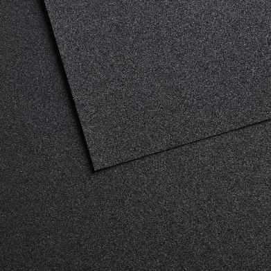 Close-up of two overlapping dark gray speckled panels with a glittery, rough texture.