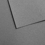 Close-up of dark gray textured foam panels overlapping at angle lines on a speckled surface.