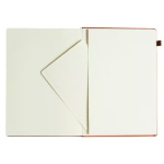 Open notebook with cream pages; left page has a diagonal corner pocket, right page blank, red cover edges visible.