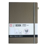 Brown hardcover notebook with a gray elastic band and a white label reading 'Ruled Notebook' and 140 g/m² paper.