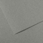 Close-up of overlapping gray textured paper sheets on a fabric-like background.