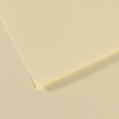 Two pale cream sheets of textured paper overlapped on a beige surface.