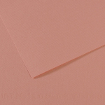 Close-up of light pink textured paper with a folded corner and layered edges.