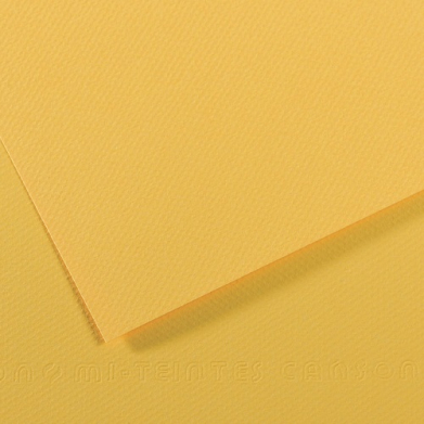 Two overlapping sheets of yellow textured paper on a yellow surface with soft shadows.