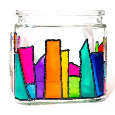 Colorful irregular glass shards arranged inside a clear mason jar, creating a stained-glass effect.